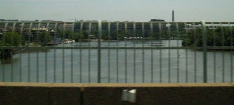 looking through the railings whilst taxi-ing into d.c. ~ that's the washington monument in the distance